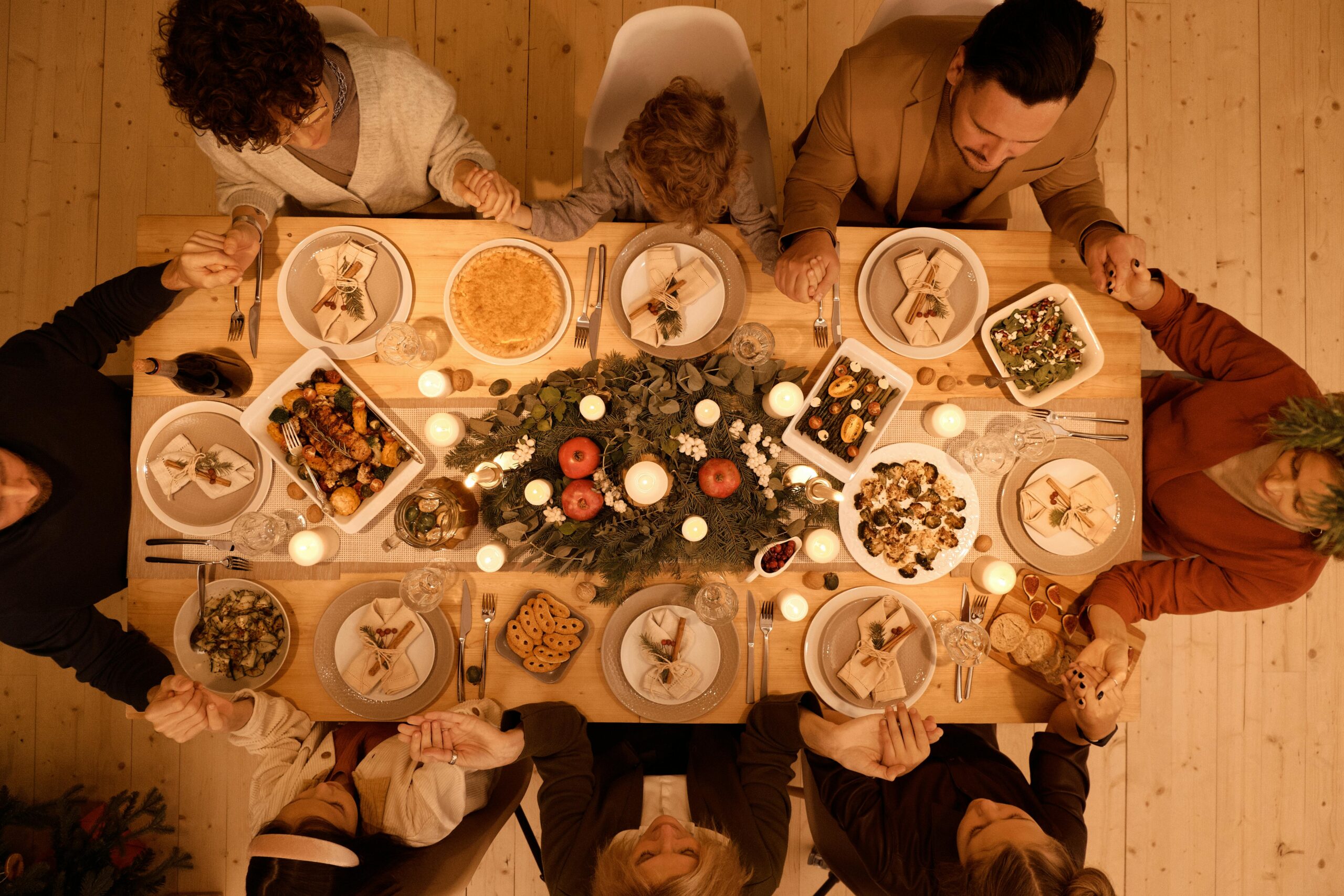 Family gathered around a beautifully set table for a festive Christmas dinner celebration.